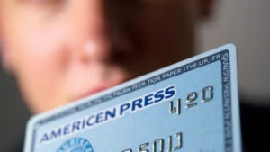 Close-up of an American Express card showing the four-digit security code on the front right side, with the card details visible but faces blurred for privacy, modern lighting emphasizing security features