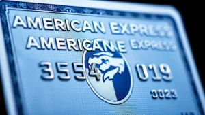 Close-up photograph of the back of an American Express card showing the four-digit security code in the upper right corner above the signature strip, with the card tilted to show depth and security features, professional lighting highlighting the embossed numbers and holographic elements